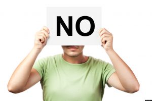 young man holding a billboard with word no isolated on white background; Shutterstock ID 87216109; PO: aol; Job: production; Client: drone