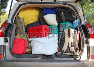 car overloaded with suitcases and duffle bag for family travel